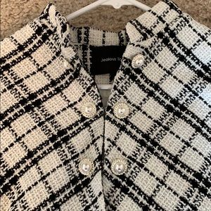 Classy black and white poncho with fun buttons